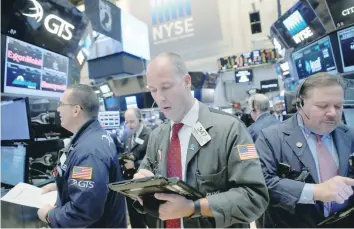  ?? — Reuters ?? Traders work on the trading floor at the New York Stock Exchange (NYSE) in Manhattan.