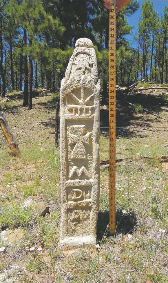  ?? COURTESY LOUIS SERNA ?? The Ponil pillar in the Valle Vidal stands nearly 33 inches tall and is carved with symbols not typical of Northern New Mexico cultures. To prevent vandalism or theft, its exact location is highly guarded by Carson National Forest personnel.