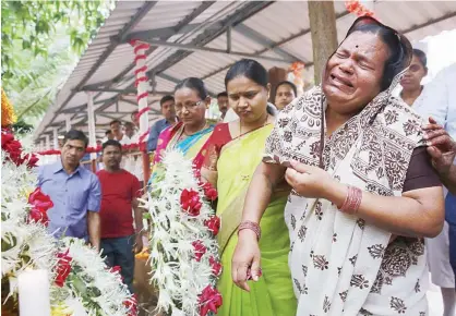  ?? Associated Press ?? Shushila Ughade (right) who lost her husband in Mumbai terror attacks, cries at the memorial on the ninth anniversar­y in Mumbai on Sunday.