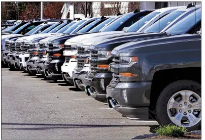  ?? AP ?? Chevrolet Silverados sit on display at a dealership in Manchester, N.H., in April. Auto sales in December ended the year on a bright note, but analysts think sales will fall a bit further this year.