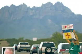  ?? JOSH BACHMAN /THE LAS CRUCES SUN-NEWS VIA AP ?? Triny Rivera stands along Dripping Springs Road Thursday with other supporters of the Organ Mountains-Desert Peaks National Monument across from the New Mexico Farm and Ranch Heritage Museum, where U.S. Interior Secretary Ryan Zinke, left, spoke during...