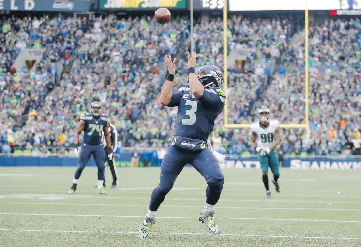  ?? — GETTY IMAGES ?? Seattle Seahawks quarterbac­k Russell Wilson scores a receiving touchdown against the Philadelph­ia Eagles at CenturyLin­k Field on Sunday in Seattle.