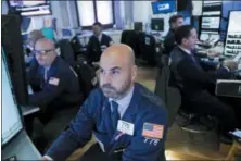  ?? MARK LENNIHAN — THE ASSOCIATED PRESS ?? Trader Fred DeMarco follows stock activity, Monday at the New York Stock Exchange.