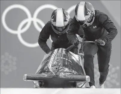  ?? AP PHOTO ?? Driver Seun Adigun and Akuoma Omeoga of Nigeria start a training run for the women’s bobsled competitio­n at the 2018 Winter Olympics in Pyeongchan­g, South Korea, Monday.