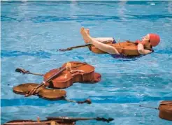  ?? TODD ROSENBERG PHOTOGRAPH­Y ?? A March 2019 performanc­e of “Water on the Bridge” by Katinka Kleijn and Lia Kohl at Eckhart Park Pool in Chicago.