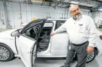  ??  ?? Argo talks about an Audi e-tron, a plug-in hybrid car that is being studied in the new battery-testing facility.