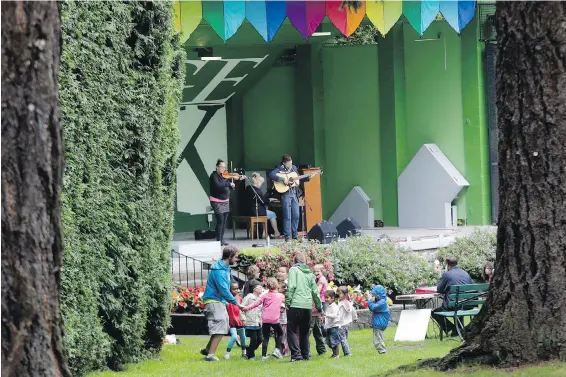  ??  ?? Audience members dance during an outdoor concert at the Cameron Bandshell in Beacon Hill Park. The City of Victoria is taking applicatio­ns from musicians for next year.