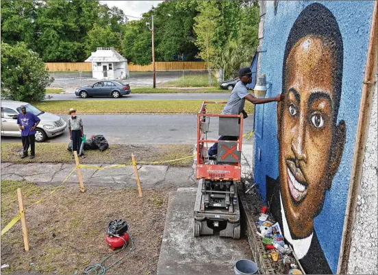  ?? HYOSUB SHIN/AJC 2020 ?? Miami-based artist Marvin Weeks, who is originally from Brunswick, works on a large mural in May 2020 in tribute to Ahmaud Arbery on the side of a building that will house the Brunswick African American Cultural Center. Arbery was shot as he jogged through a mostly white community a few miles from his home.