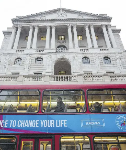  ?? SIMON DAWSON / BLOOMBERG NEWS ?? A bus outside the Bank of England. While a Bank of England interest-rate hike in the near future was once believed possible, the central bank’s Governor Mark Carney took that off the table last month.