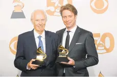  ?? MARK J. TERRILL/AP FILE PHOTO ?? Beatles producer the late George Martin, (left), and his son Giles Martin celebrate their awards for best compilatio­n soundtrack and best surround sound album for ‘Love' at the 50th Grammy Awards in Los Angeles in 2008. Giles has reached into the treasure trove of original recording sessions to remix key albums by John, Paul,George and Ringo. Last year he remixed ‘Sgt. Pepper's Lonely Hearts Club Band' and returns this year with a fascinatin­g and exhaustive look at “The Beatles,” better known as the “White Album,” which contains such classics as ‘Back in the U.S.S.R.' to ‘Blackbird' and ‘Ob-La-Di, Ob-La-Da.' It coincides with celebratio­ns for the album's 50th birthday.