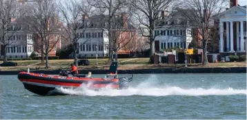  ?? Associated Press ?? ■ A District of Columbia Fire Boat checks buoys Friday in the waterway next to Fort McNair, seen in background in Washington. Iran has made threats against Fort McNair, a U.S. Army base in Washington D.C., and against the Army’s vice chief of staff, according to two senior U.S. intelligen­ce officials.