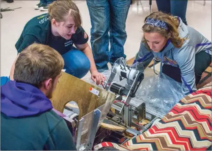  ?? WILLIAM HARVEY/RIVER VALLEY & OZARK EDITION ?? Mayflower High School robotics team members Austin Smith, from left, Briawna Stigall and Reagan Brincks unpack the robot they took to the Arkansas Rock City Regional competitio­n. The team, Metal Eagles 6640, received the Rookie All-Star Award and...