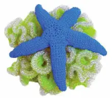  ??  ?? Rock coral crocheted in lemon-lime ice topped with a blue taffy starfish.