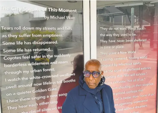  ?? Patricia Zamora ?? Michael Warr in front of his pandemic poem “The City Speaks of This Moment” as part of the 2021 SF Urban Film Fest “Mourning Is an Act of Love” installati­on. Warr and Chinese poet Chun Yu launched Two Languages / One Culture.