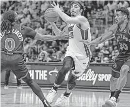  ?? AL DIAZ adiaz@miamiheral­d.com ?? Jaime Jaquez Jr., driving to the basket Sunday against Toronto’s Javon Freeman-Liberty, left, and Ochai Agbaji, scored 18 points in his second consecutiv­e impressive game.