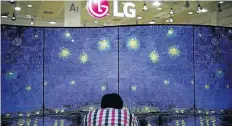  ?? Picture: REUTERS ?? CLEARER PICTURE: A man examines a double-faced OLED TV, made by LG, during the Korea Electronic­s Show 2016 in Seoul. At this year’s CES show in Las Vegas, rival Samsung revealed a new technology called QLED