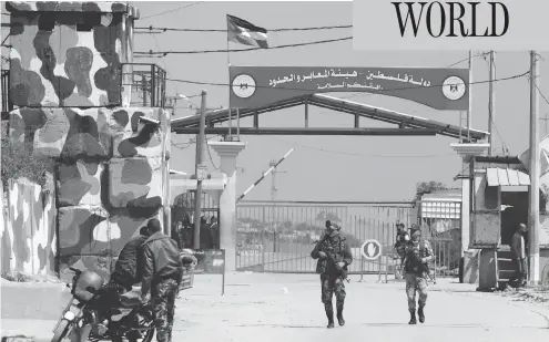  ?? MAHMUD HAMS / AFP / GETTY IMAGES ?? Hamas security forces stand guard at Erez border crossing into Israel, in Beit Hanun, in the northern Gaza Strip on Sunday. The crossing was shut down by the Islamist movement after blaming the Jewish state for the assassinat­ion of one of its officials...