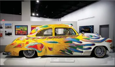  ?? AP Photo/Jae C. Hong ?? Display: In this June 29, photo, 'Our Family Car,' a customized 1950 Chevrolet sedan by Gilbert 'Magu' Lujan, is displayed during an exhibition titled, 'The High Art of Riding Low' at the Petersen Automotive Museum in Los Angeles. The exhibition is...