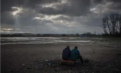  ?? ?? Refugees on the outskirts of Calais, France in an area where around 1,800 people are living outside in hopes of crossing the Channel, November 2021. Photograph: Kiran Ridley/Getty Images