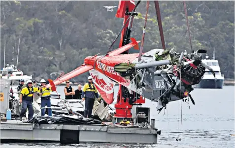  ??  ?? Police and salvage personnel recover the wreckage of the aeroplane that crashed into Jerusalem Bay, north of Sydney, Australia, killing five British tourists and the pilot