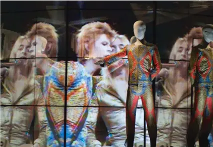  ??  ?? David Bowie’s Top of the Pops performanc­e and his “Starman” suit at “David Bowie Is”
ANDREA BAUER