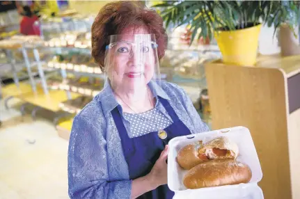  ?? KRISTEN ZEIS/STAFF ?? Luz Esteban shows off the Filipino pepperoni bread at Glory’s Bakery in Virginia Beach.