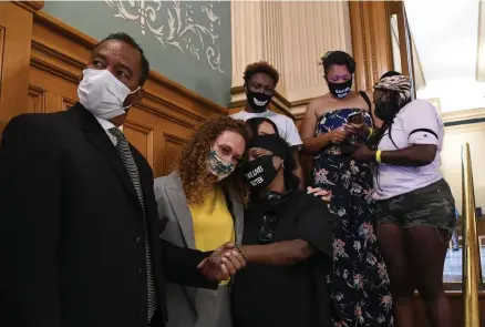  ?? Kathryn Scott, special to The Denver Post ?? Sheneen McClain, third from left, the mother of Elijah McClain, is supported by her attorney Mari Newman, second from left, as family members watch the police reform bill, Senate Bill 20-217, pass the House with bipartisan support. Elijah McClain was killed by Aurora police in August 2019. The Rev. Promise Lee, left, represente­d the family of De'Von Bailey, who was killed by Colorado Springs police.