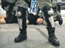  ??  ?? Riot police detain an anti-government protester at a recent rally in Tseung Kwan O, Hong Kong.
REUTERS