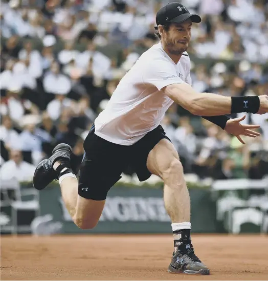  ??  ?? 0 Andy Murray stretches to return the ball to Japan’s Kei Nishikori during their French Open quarter-final on Court Philippe Chatrier. The world No 1 was outplayed in the opening set but fought back to win 2-6, 6-1, 7-6 (7/0), 6-1.