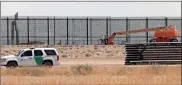  ?? Herika Martinez/afp/getty Images North America/tns ?? A Border Patrol unit drives by the constructi­on site of a new section of the border wall between the U.S. city of El Paso, Texas and Ciudad Juarez, Chihuahua state, Mexico, on Aug. 17.