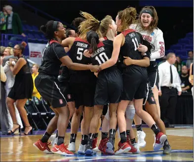  ?? Associated Press ?? Group hug: Members of the Stanford women's team celebrate after defeating Notre Dame to win the Lexington regional final Sunday in Lexington, Ky.