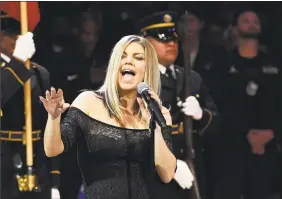  ??  ?? Singer Fergie performs the national anthem prior to an NBA All-Star basketball game Sunday in Los Angeles.