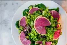  ?? Courtesy of Cory Baker ?? The house salad at Emerson’s features mixed greens and watermelon radish and is dressed with citrus dill vinaigrett­e.