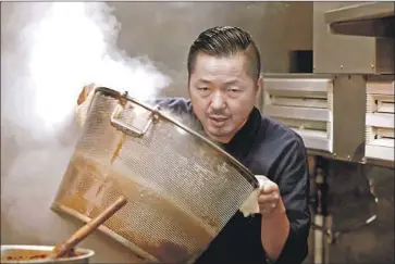  ?? Gunpowder & Sky ?? CHEF Osamu Tomita gets to work at his restaurant, which attracts fans from near and far, in “Ramen Heads.”