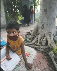  ??  ?? A student attends a sidewalk class for underprivi­leged children.