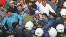  ?? AFP ?? Sharif supporters scuffle with police as the former Punjab CM arrives at the court amid strict security.