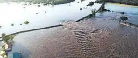  ?? YELL COUNTY SHERIFF’S DEPARTMENT ?? Water rushes through a breached levee along the Arkansas River on Friday in Dardanelle, Arkansas. Floodwater­s coming through the 40-foot hole threaten hundreds of homes.