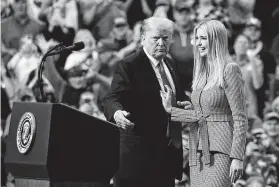  ?? Carolyn Kaster / Associated Press ?? President Donald Trump greets his daughter Ivanka as she arrives to speak during a rally at the IX Center in Cleveland. The Chinese government granted 18 trademarks to companies linked to Trump and his daughter.