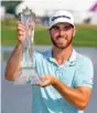  ?? AP PHOTO/ANDY CLAYTON- KING ?? Matthew Wolff holds the trophy after winning the 3M Open on Sunday in Blaine, Minn.