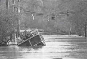  ?? Tenn. GEORGE WALKER IV/THE TENNESSEAN ?? A firetruck is revealed as flood waters from the Harpeth River recede on March 29 in Nashville,