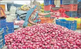  ?? PTI ?? A woman sorts onions at a wholesale vegetable market. The BJP has taken on the government over the rise in prices of the kitchen staple.