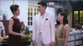  ?? WARNER BROS. ENTERTAINM­ENT ?? Michelle Yeoh, left, Henry Golding and Constance Wu share a scene from “Crazy Rich Asians.”