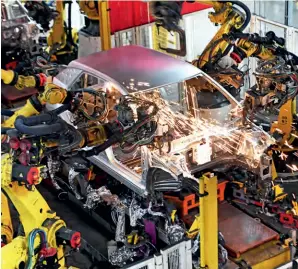  ?? ?? Robots work on a vehicle production line at SAIC Motor in Ningde, Fujian Province, on 7 February