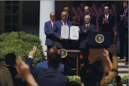  ?? EVAN VUCCI — THE ASSOCIATED PRESS FILE ?? President Donald Trump poses for a photo after signing the Paycheck Protection Program Flexibilit­y Act during a news conference in the Rose Garden of the White House.