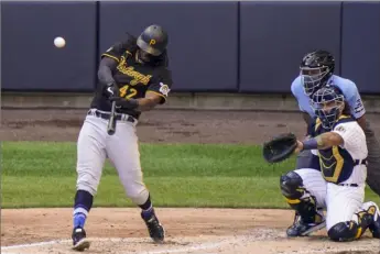  ?? Associated Press ?? Josh Bell hits the Pirates’ second home run of the game, a two- run shot in the fourth inning off Brewers starter Brandon Woodruff.