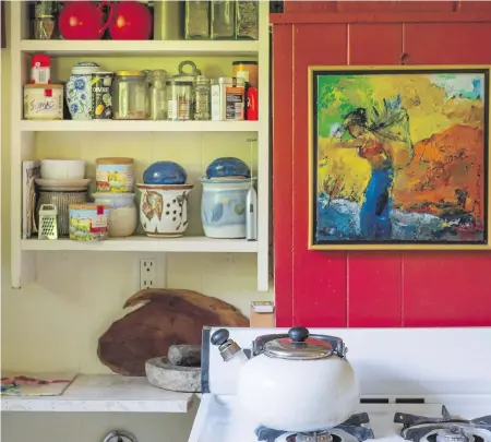  ??  ?? Every inch of space is put to good use in the mini kitchen and here is a perfect spot for condiments and interestin­g pots. The painting over the stove is by a Bangladesh­i artist.