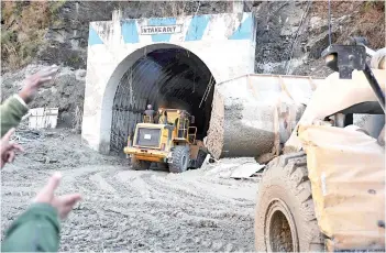  ?? — AFP photo ?? A bulldozer and rescue teams work at the entrance of a tunnel blocked with debris during rescue operations in Tapovan of Chamoli district.