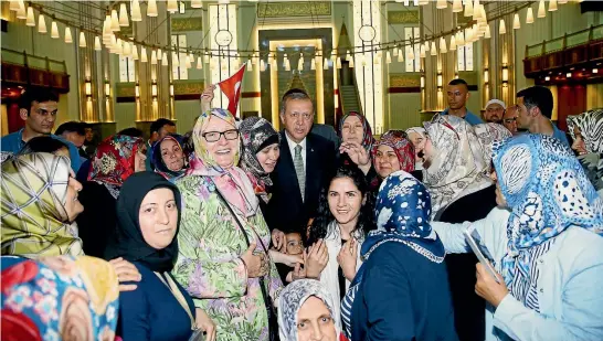  ?? REUTERS ?? Turkish President Recep Tayyip Erdogan poses for photos with female supporters following Friday prayers at an Ankara mosque yesterday.