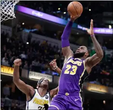  ??  ?? Los Angeles Lakers forward LeBron James (23) shoots over Indiana Pacers center Myles Turner (33) during the first half of an nBA basketball game in Indianapol­is, on Tuesday. AP PHOTO/MICHAEl CONROy
