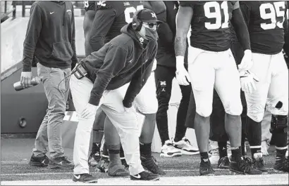  ?? CARLOS OSORIO Associated Press ?? watches as his Michigan team loses to an 0-5 Penn State program to fall to 2-4 this season. JIM HARBAUGH